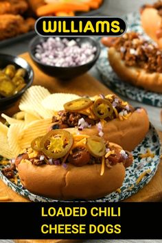 two loaded chili cheese dogs with chips on the side