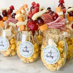 several wine glasses filled with snacks and cheeses