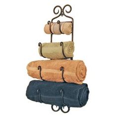 three towels are stacked on top of each other in a rack with two towel holders