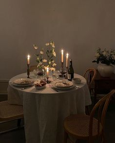 a table with plates and candles on it