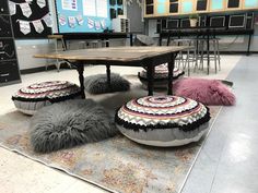 an area rug with pom poms on it in front of a table and chairs