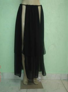 a mannequin wearing a black skirt and top with an open slit on the bottom