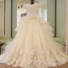 a wedding dress on display in front of a mirror