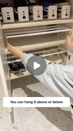 a young boy is reaching for shoes in a shoe rack with the caption you can hang it above or below