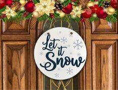 a sign that says let it snow hanging on a door with christmas decorations around it