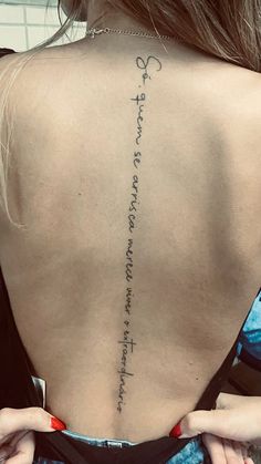 the back of a woman's neck with writing on it