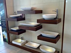 a display case with bowls and plates on it