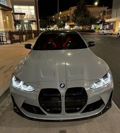 a silver sports car parked in front of a building