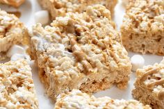 rice krispy treats with marshmallows being held by someone's hand