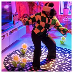 a woman wearing a virtual reality headset standing on a table with flowers in front of her