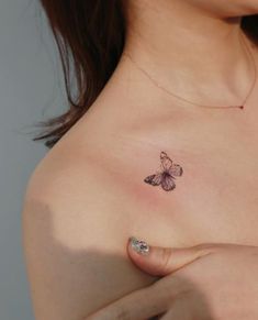 a woman's breast with a butterfly tattoo on her left shoulder and right breast