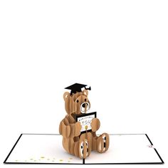 a graduation card with a teddy bear holding a sign