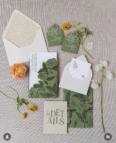 the wedding stationery is laid out on top of each other with flowers and cards