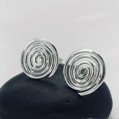 Recycled Sterling Silver Spiral Stud Earrings Handmade Spiral stud earrings.    Available in three sizes Approx 8 mm dia Approx 10 mm dia and 15 mm Sterling Silver ear Scrolls supplied All jewellery is made with silversmithing techniques. Alba Cara is registered at the Edinburgh Assay Office in Scotland, all jewellery will be legally hallmarked as required.  Please be careful when ordering. Images are taken using the macro function on camera,  This highlights jewellery intricate design aspects a Modern Twist Spiral Wrap Earrings As Gift, Modern Twist Spiral Wrap Earrings, Unique Spiral Wrap Earrings As Gift, Unique Spiral Wrap Earrings For Gift, Contemporary Jewelry Design, Spiral Earrings, Contemporary Jewellery, Recycled Sterling Silver, Jewelry Earrings Studs