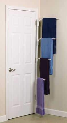 the door is open and there are towels hanging on it