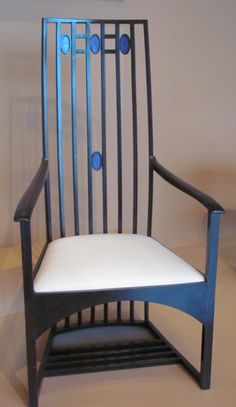 a black chair with a white seat and blue trim around the armrests is shown