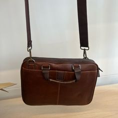 Never Worn Brown Leather Briefcase Classic Cases With Leather Lining For Daily Use, Brown Briefcase With Removable Pouch For Everyday Use, Classic Rectangular Cases For Everyday, Elegant Brown Case For Everyday Use, Elegant Everyday Brown Case, Elegant Brown Everyday Case, Brown Leather Briefcase With Removable Pouch, Brown Rectangular Business Case Bag, Modern Brown Cases For Everyday Use