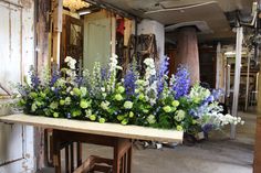 an arrangement of flowers is displayed on a table