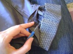 a person is cutting through a piece of fabric to tie a tie with a pair of scissors