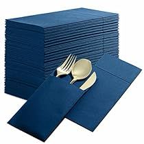 a stack of blue napkins with silverware on top