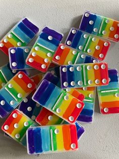 rainbow colored dominos with white dots on them