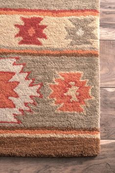 an area rug is shown on the floor with wood floors and wooden planks in the background