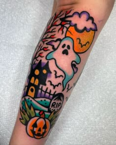 a person with a halloween themed tattoo on their arm