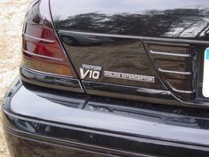 the back end of a black car with a license plate