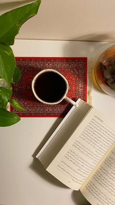 an open book next to a cup of coffee