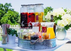 a table topped with bottles and glasses filled with different types of drinks on top of it