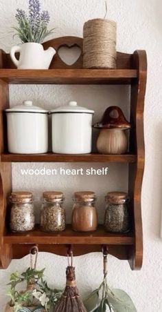 an old wooden shelf with jars and other items on it