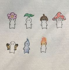 a group of small cartoon figures on a white surface with flowers and mushrooms in the background