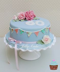 a blue cake with pink roses on top