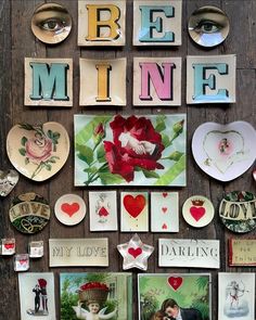 many different pictures and magnets are arranged on a wall with the words be mine