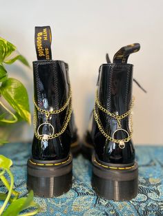 Lunar Lotus Boot Chains are the perfect way to spice up your Doc Martens or Combat Boots!  The chain length fits both Platform and Classic heel heights - Each order comes with a set of two chains of the same style - Each set is handmade. *New* Heavy Gauge Chains with detachable charms for easy mixing and matching! This Set Includes: - 2 Gold Mushroom Charms (Detachable) - Clips: 18k Gold Plated - Chain: Imitation 12k Gold - Fittings: 18k Gold Plated Boot Chains, Moon Gold, Wrap Boots, Gold Baroque, Floral Moon, Classic Heels, Gold Moon, Shoe Clips, Moon Charm