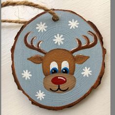 a wooden ornament with a reindeer's face painted on it