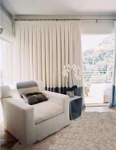 a white couch sitting in front of a window