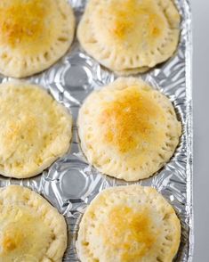 six empandors on a baking tray ready to be baked