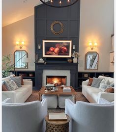 a living room with couches, chairs and a fire place in the middle of it