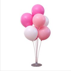 a bunch of pink and white balloons on a stick in front of a white background