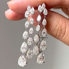 10k White Gold Long Dangle Drop Earrings, Glittering Pear Cut Colorless Moissanite Bridesmaid Earrings, Chandelier Earrings, Wedding Gift  ✹✹𝐖𝐞𝐥𝐜𝐨𝐦𝐞 𝐭𝐨 𝑻𝒉𝒆𝑩𝒂𝒏𝒅𝒔𝑺𝒉𝒐𝒑✹✹ ★ 𝑺𝒕𝒐𝒏𝒆𝒔 𝑫𝒆𝒕𝒂𝒊𝒍𝒔 ★ ● Stone Shape:- Pear Cut & Marquise Cut  ● Stone Type:- Simulated Diamond, Moissanite ● Stone Size:- 4x2.50 mm, 5x3 mm, 6x4 mm, 7x5 mm & 5x2.50 mm  ● Color:- DEF ● Clarity: VVS-VS ● Cut Grade: Excellent ● Making Process: Handmade - Crafted by our experienced team ★ 𝑰𝒕𝒆𝒎 𝑫𝒆𝒕𝒂𝒊𝒍𝒔:- ☛ Metal Purity: Solid Gold (10KT, 14KT, 18KT); Silver(925 Sterling, 935 Argentium), 950 Platinum ☛ Metal Tone: Yellow, White, Rose ☛ Stamp/Hallmark: Yes ★ 𝑪𝒖𝒔𝒕𝒐𝒎𝒊𝒛𝒂𝒕𝒊𝒐𝒏:- ☛ Customized Design Jewelry. ☛ All cuts which you dream to make with moissanite. ☛ Updating every step o Diamond Wedding Earrings, Diamond Earrings Wedding, Long Bridal Earrings, Gold Chandelier Earrings, Gold Engraving, Gold Chandelier, Platinum Metal, Earrings Long, Marquise Cut