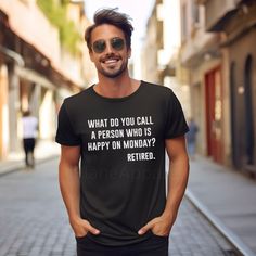 a man standing in the street wearing a t - shirt that says, what do you call a person who is happy on monday? retired