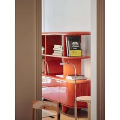 an orange book shelf with books on it