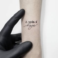 a person holding their arm up with a tattoo on it's left forearm and the words, aydda e roge written in curs