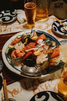 a plate full of food sitting on top of a table next to glasses and utensils