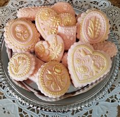 heart shaped cookies on a plate with lace doily