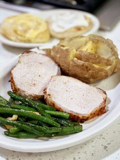 a white plate topped with meat and green beans