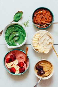 four bowls filled with different types of ice cream and toppings next to spoons