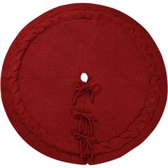 a red round rug with braiding around the edges and a hole in the middle