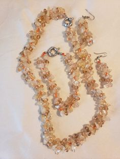 "This parure jewelry set features a 19\" necklace, an 8\"bracelet and 2.25\" long earrings.  They are glass chips strung onto orange thread.  All pieces appear in very good condition.   Thanks for stopping by.   Please don't hesitate to contact seller with any questions." Orange Round Glass Bead Jewelry, Adjustable Amber Jewelry With Lobster Clasp, Elegant Orange Glass Jewelry, Adjustable Orange Costume Jewelry, Orange Adjustable Costume Jewelry, Orange Jewelry With Natural Stones For Jewelry Making, Adjustable Round Orange Jewelry, Adjustable Orange Nickel-free Necklace, Adjustable Orange Crystal Necklace With Natural Stones